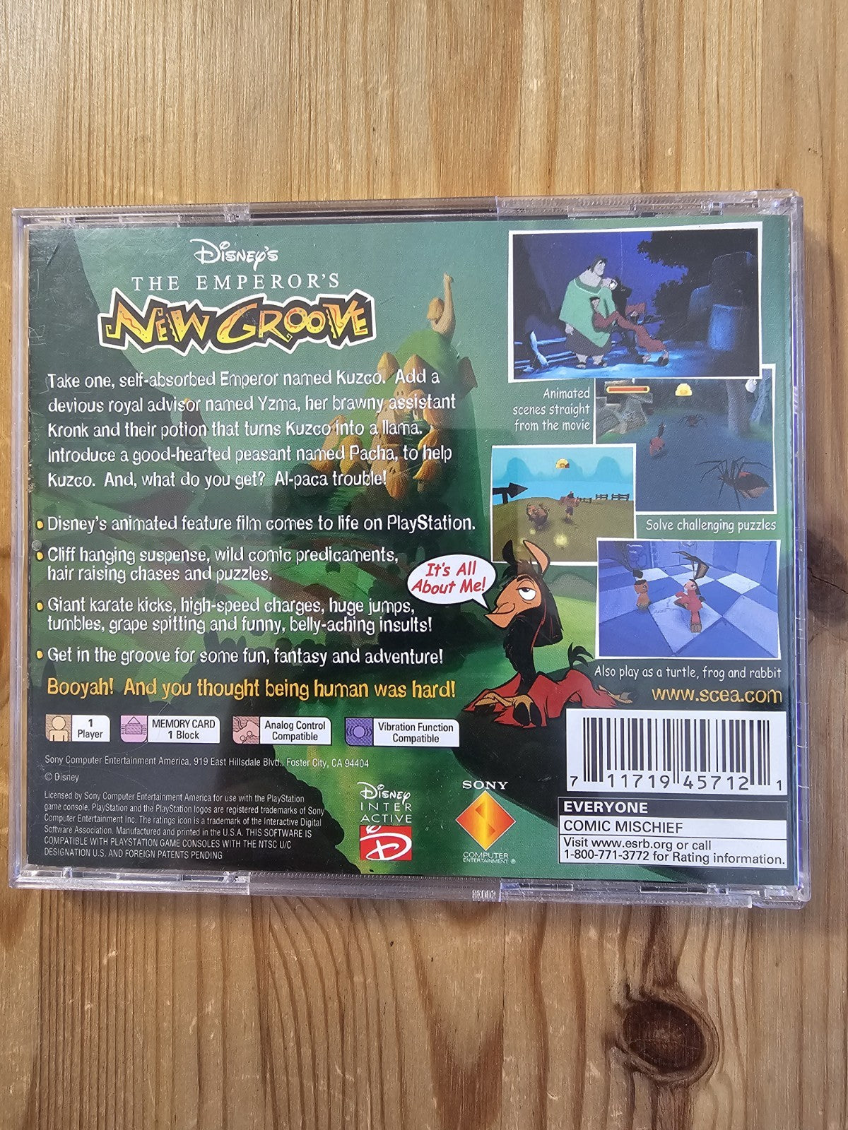 Back cover of 'The Emperor's New Groove' PlayStation game case on a wooden surface